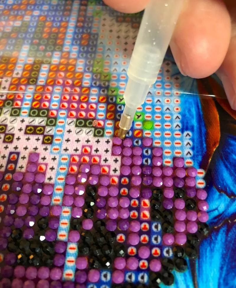 Placing diamonds on the canvas of the Aesthetic Claudia Hodgins Anime Diamond Painting