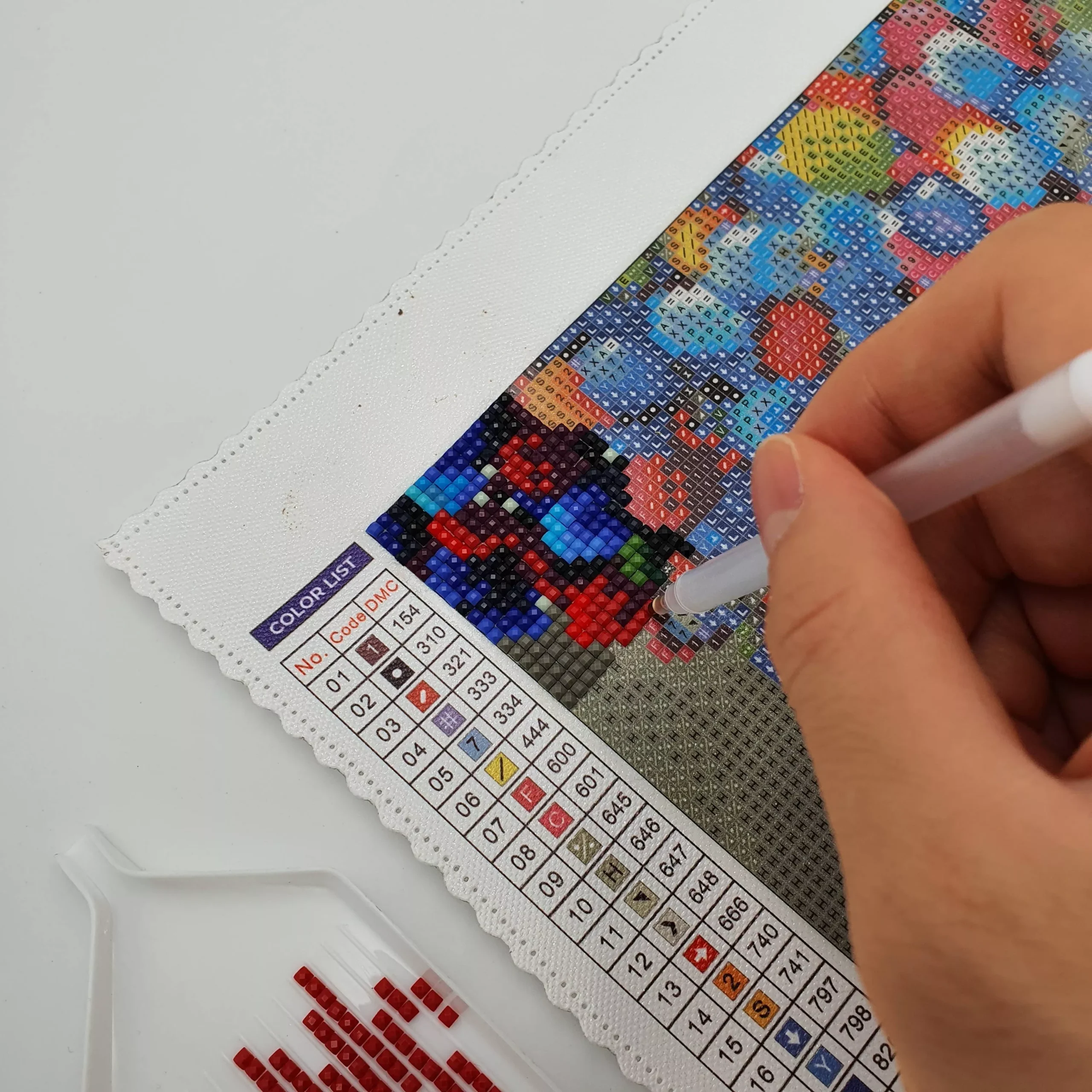 placing diamonds on a canvas for diamond painting